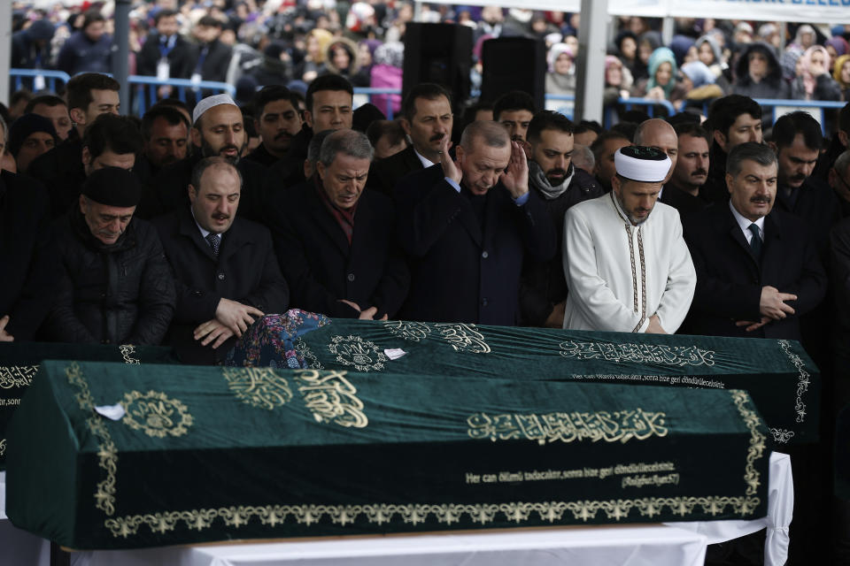 Turkey's President Recep Tayyip Erdogan, center, joins hundreds of mourners who attend the funeral prayers for nine members of Alemdar family killed in a collapsed apartment building, in Istanbul, Saturday, Feb. 9, 2019. Erdogan says there are "many lessons to learn" from the collapse of a residential building in Istanbul where at least 17 people have died.(AP Photo/Emrah Gurel)