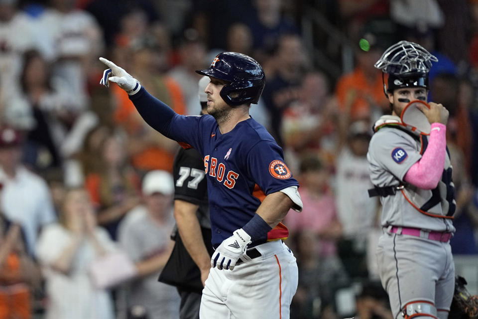 Houston Astros' Alex Bregman, left, celebrates after hitting a home run as Detroit Tigers catcher Eric Haase watches during the fifth inning of a baseball game Sunday, May 8, 2022, in Houston. (AP Photo/David J. Phillip)