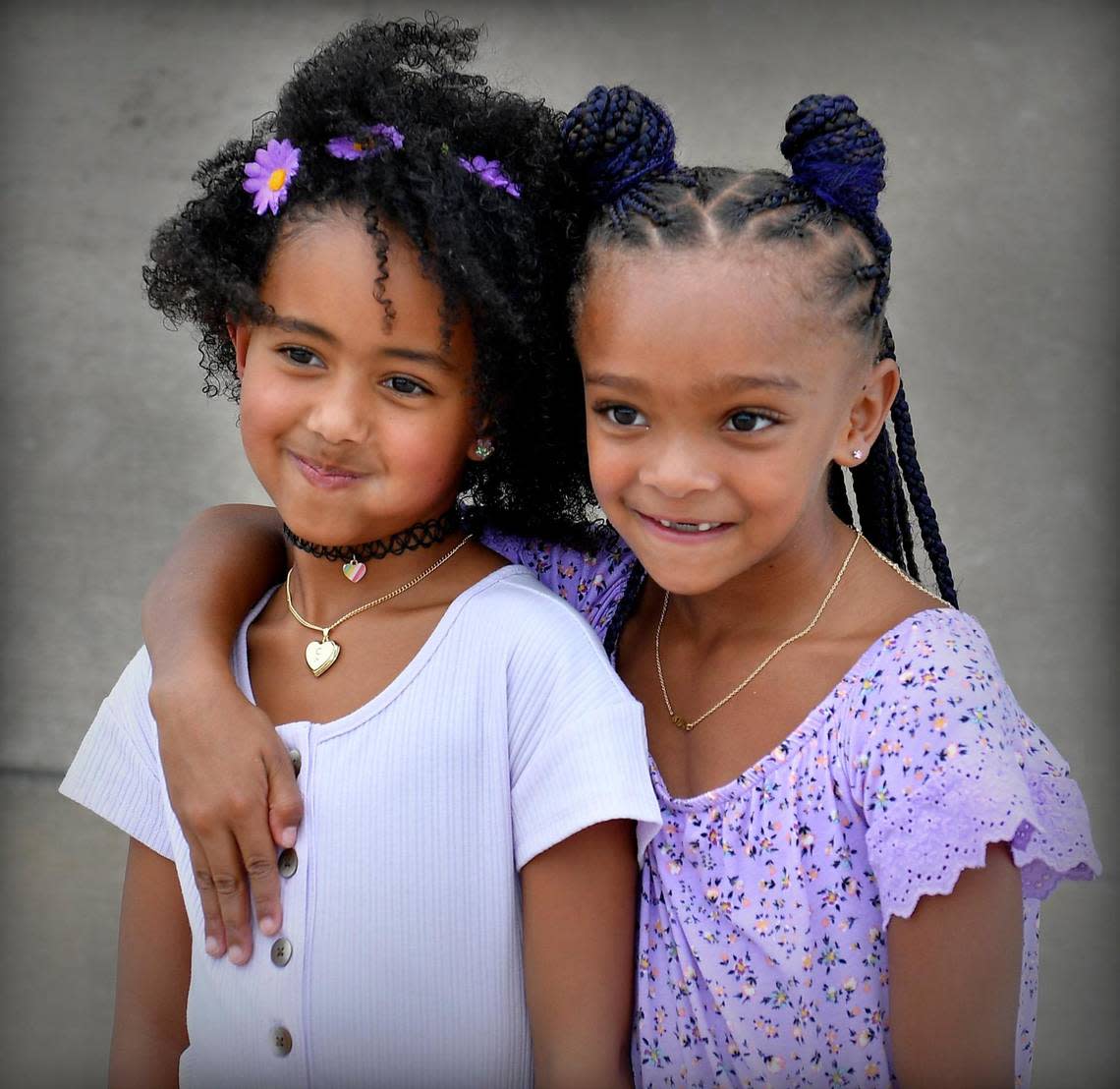 Riley Johnson, left, and Clover Taylor, both 7, strike a pose for a portrait by Daniel Alexander during the 6th Annual KC Curly Photoshoot, a day when women and girls of color and of all ages can bond over hair.