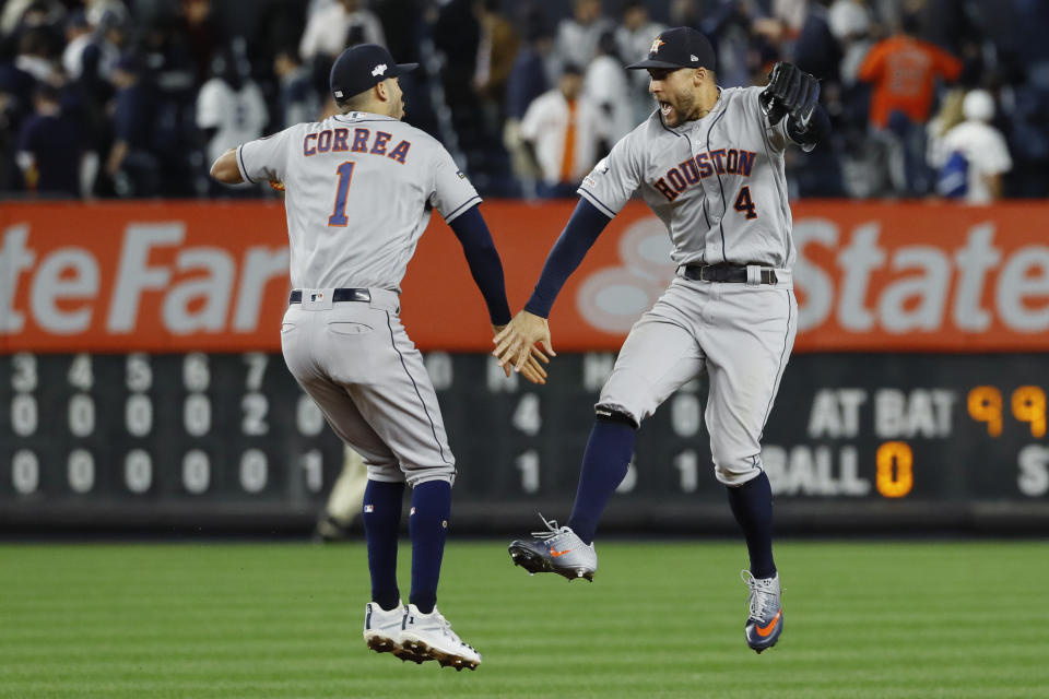 Houston Astros shortstop Carlos Correa, left, and center fielder George Springer celebrate after their 4-1 win against the New York Yankees in Game 3 of baseball's American League Championship Series Tuesday, Oct. 15, 2019, in New York. (AP Photo/Matt Slocum)
