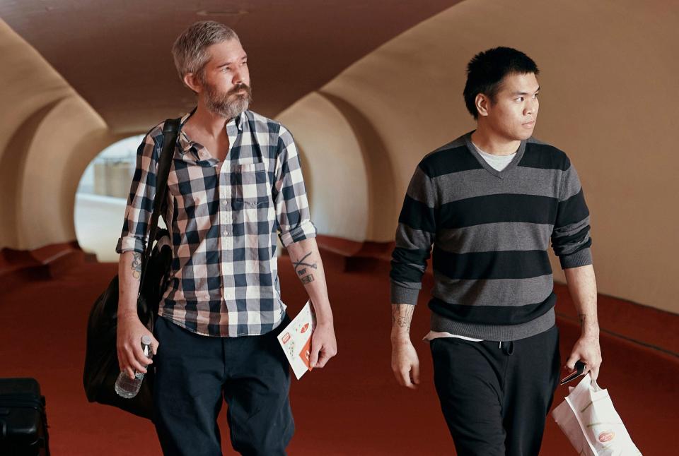 American's Andy Huynh, right, and Alex Drueke are seen arriving a New York hotel on Friday after returning from Saudi Arabia.