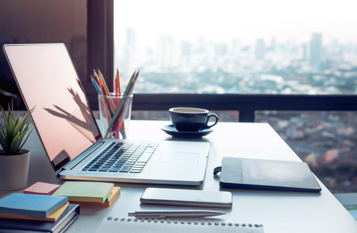 Modern ergonomic work table with computer laptop and cityscapes viewfrom window.Business concepts ideas.Strategy analysis