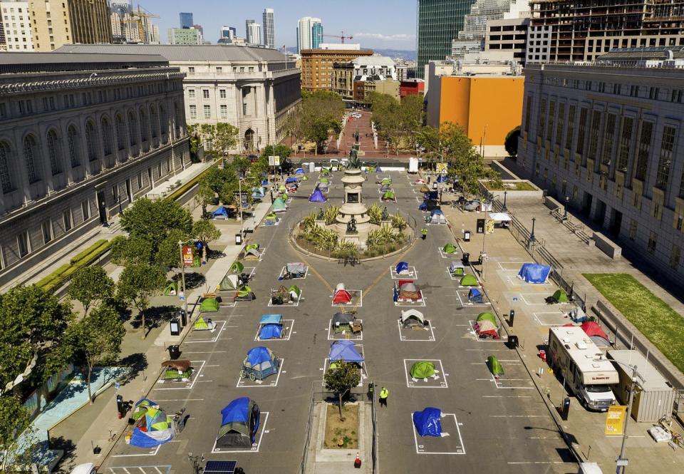 Rows of tents in squares to keep them apart.