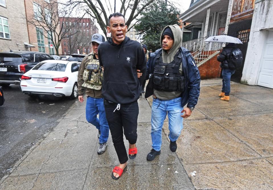 Federal agents escort a person out of a home in the Bronx where illegal migrant squatters have been living in the basement on April 3, 2024. Matthew McDermott