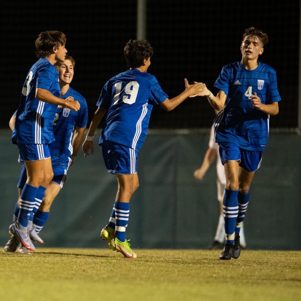 Memorial’s Kole Stratman (4) exchanges a celebratory handshake with Memorial’s Tristan Tas (19) after scoring a goal during the Memorial Tigers vs Castle Knights game at Memorial High School in Evansville, Ind., Wednesday evening, Sept. 14, 2022. 