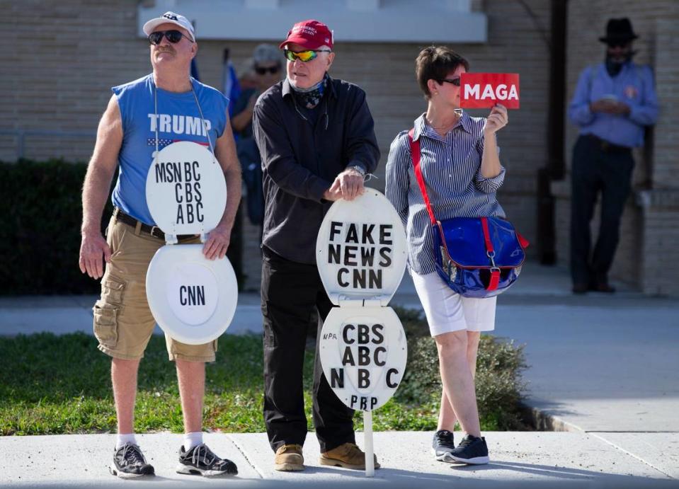 Trump supporters await the arrival of US President Donald Trump and his motorcade along Southern Blvd on his way to Mar-a Lago in West Palm Beach on Wednesday, January 20, 2021.