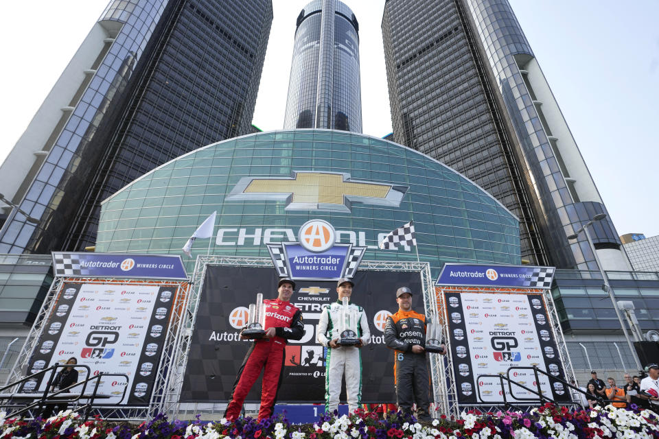 Winner Alex Palou, center, celebrates with second-place finisher Will Power, left, and third-place finisher Felix Rosenqvist , right, after the IndyCar Detroit Grand Prix auto race in Detroit, Sunday, June 4, 2023. (AP Photo/Paul Sancya)