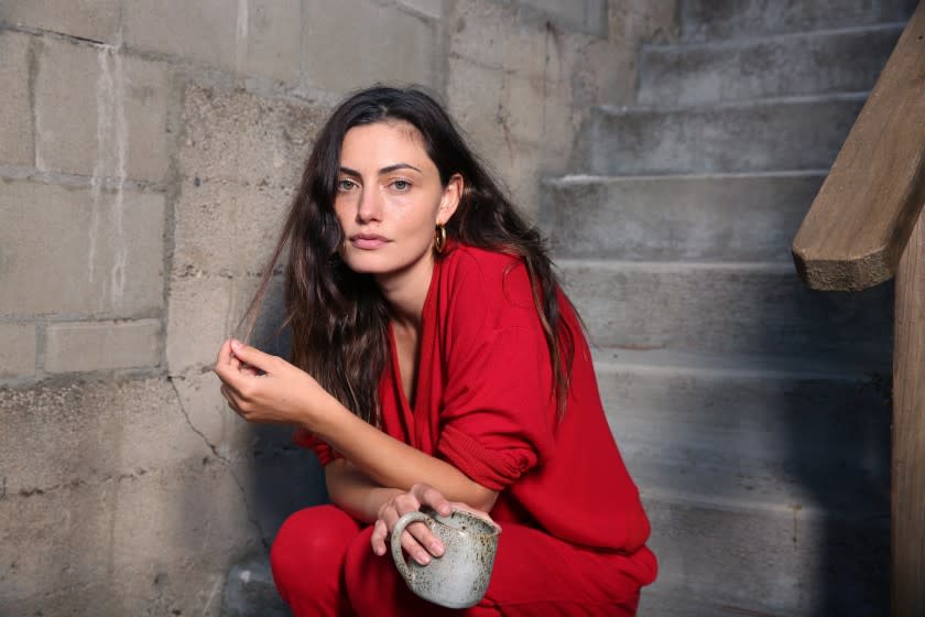 LOS ANGELES , CA - OCTOBER 22: Phoebe Tonkin poses for a portrait wearing her Los Angeles-made sustainable loungewear line called LESJOUR! which will launch this month in her home on Thursday, Oct. 22, 2020 in Los Angeles , CA. She is wearing red, coined "fancy" in the line. (Dania Maxwell / Los Angeles Times)