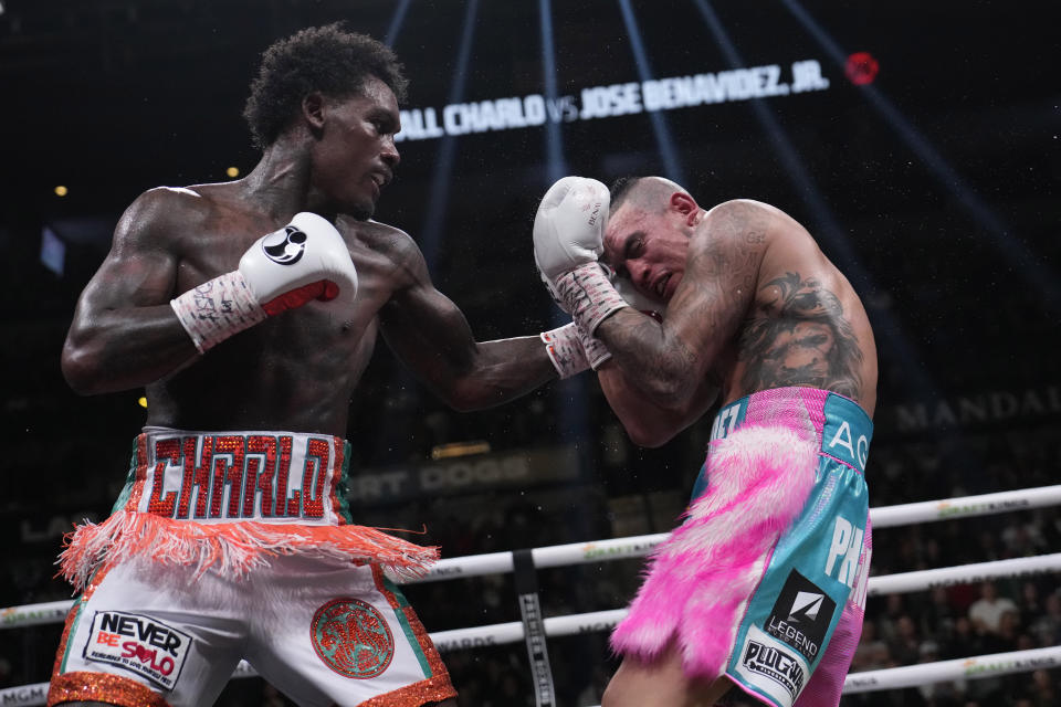 Jermall Charlo, left, hits Jose Benavidez Jr., right, during a middleweight boxing match Saturday, Nov. 25, 2023, in Las Vegas. (AP Photo/John Locher)