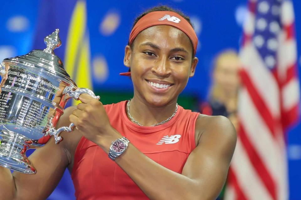 <p>J. Conrad Williams Jr./Newsday RM/Getty </p> Coco Gauff holding her trophy after defeating Aryna Sabalenka to win her first grand slam in the the Women