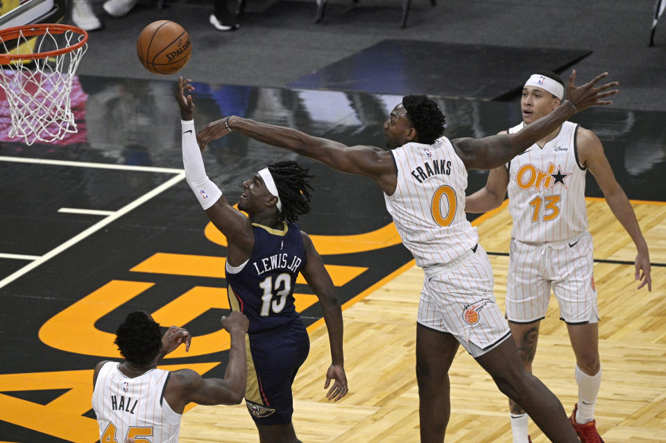 Orlando Magic forward Robert Franks (0) deflects a shot attempt by New Orleans Pelicans guard Kira Lewis Jr. (13) as Magic forward Donta Hall (45) and guard R.J. Hampton (13) watch during the second half of an NBA basketball game Thursday, April 22, 2021, in Orlando, Fla. (AP Photo/Phelan M. Ebenhack)