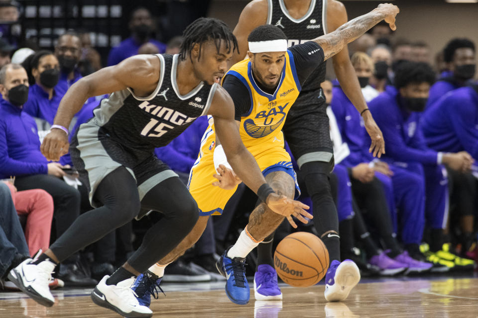 Golden State Warriors guard Gary Payton II (0) guards Sacramento Kings guard Davion Mitchell (15) during the first quarter of an NBA basketball game in Sacramento, Calif., Sunday, Oct. 24, 2021. (AP Photo/Randall Benton)