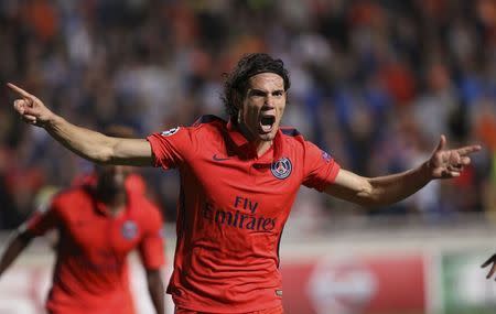 Paris Saint-Germain?s Edinson Cavani celebrates with his teammates after scoring against APOEL Nicosia's during their Champions League Group F soccer match at GS Stadium in Nicosia October 21, 2014. REUTERS/Andreas Manolis