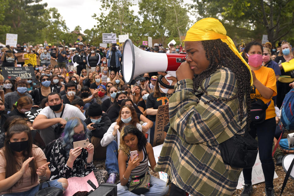 Demonstration co-organizer Alyssa Brown chokes up as she speaks during a protest, Saturday, June 6, 2020, in Simi Valley, Calif., over the death of George Floyd. Floyd died after he was restrained in police custody on Memorial Day in Minneapolis. (AP Photo/Mark J. Terrill)