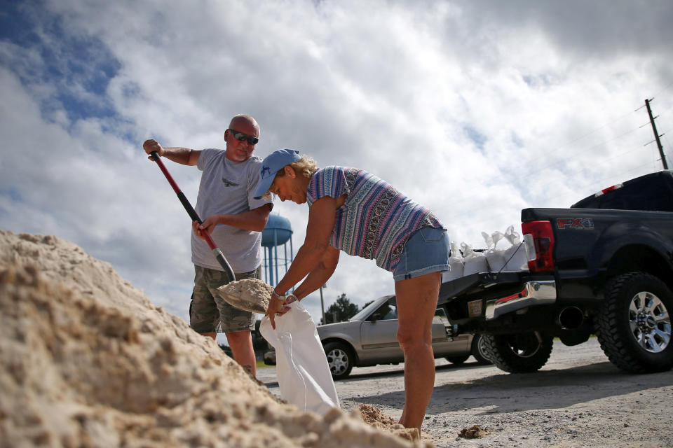 Image: Rodney and Peggy Thomas fill sandbags as Tropical Storm Sally approaches in Bay St. Louis (Jonathan Bachman / Reuters)