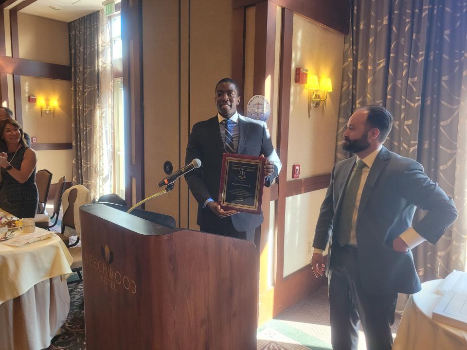 Worcester court officer and nonprofit leader Woodrow Adams Jr., left, receives the Liberty Bell Award from Worcester County Bar Association President-Elect Leonardo Angiulo Monday at the Beechwood Hotel.