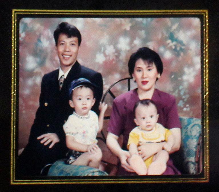 This reprodcution of an undated handout photograph released by the family of Sugianto Lo on March 10, 2014 in Medan, located on Sumatra island, shows Indonesian couple Sugianto Lo (L) and wife Vinny Chyntya (R) holding their two children