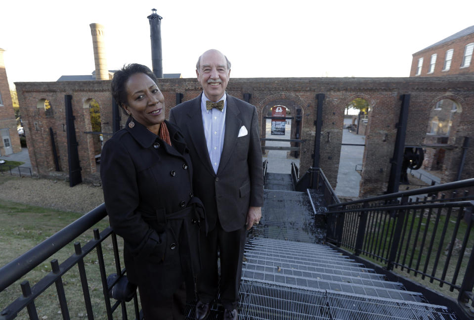 Christy Coleman, left, director of the American Civil War Center at Tredegar Iron Works, left, and Waite Rawls of the Museum of the Confederacy, pose in front of the ruins of the old Tredegar Iron Works in Richmond, Va., Wednesday, Nov. 13, 2013. (AP Photo/Steve Helber)