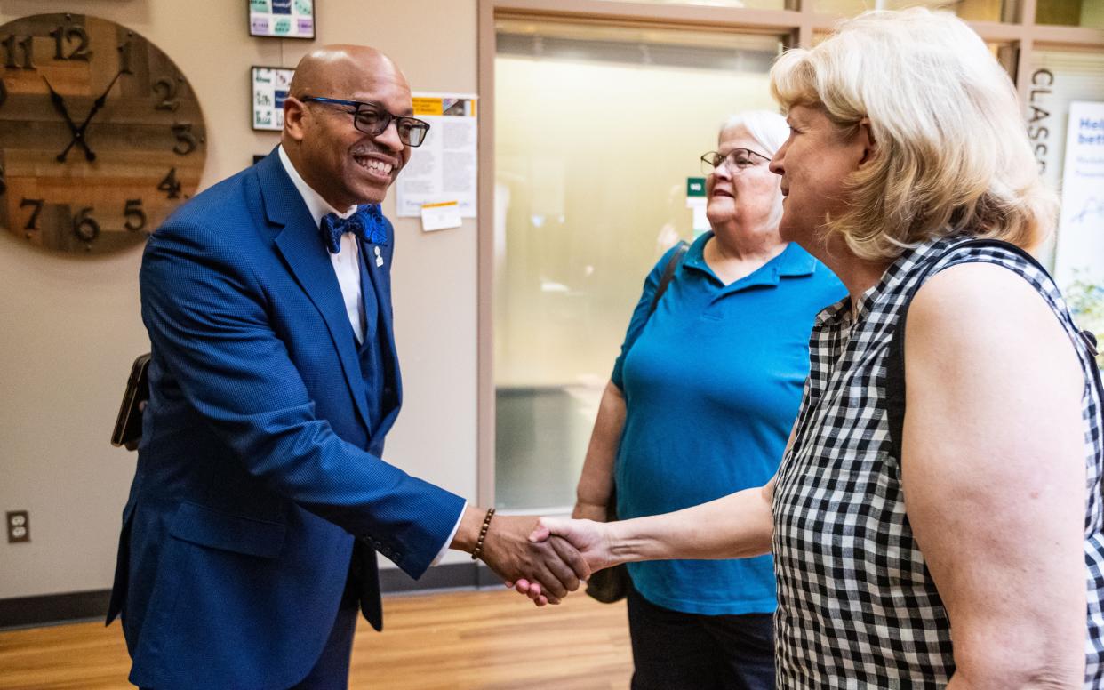 Claude Tiller, the superintendent of the Green Bay School District, shakes hands with former school board member Jean Marsch of Allouez at a meet-and-greet July 18 at the Aging & Disability Resource Center of Brown County in Green Bay. He is under review for comments he made recently on an Atlanta-based talk radio show.