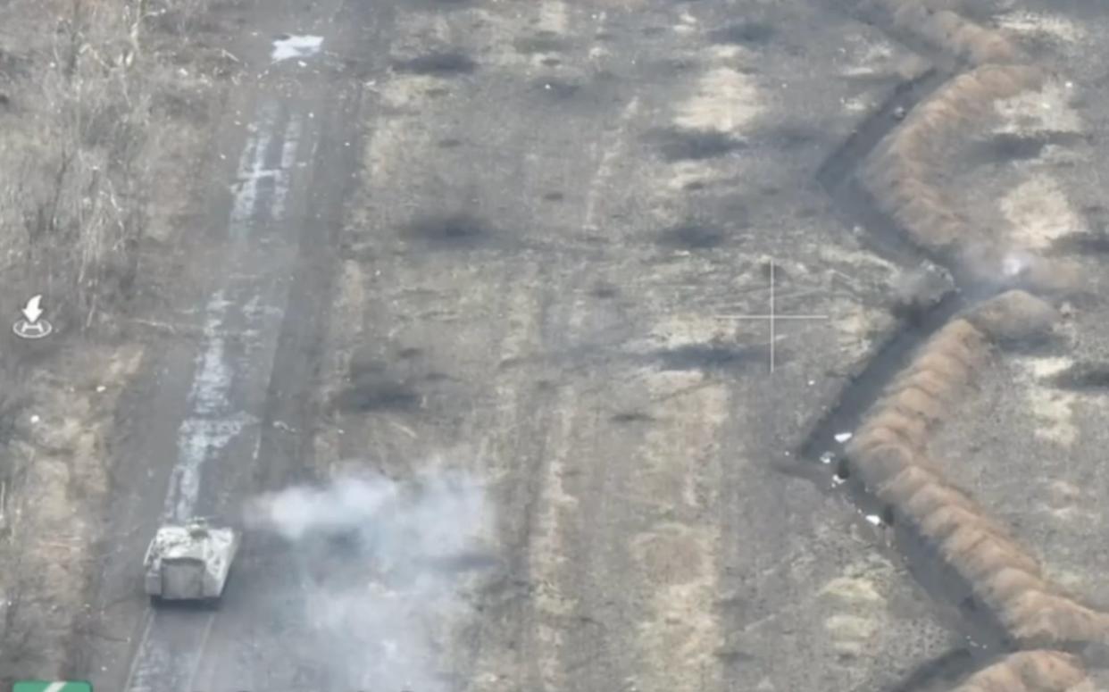 An armored fighting vehicle with Ukrainian troops inside fires on Russian trenches in the town of Ivanivske, to the west of Bakhmut.