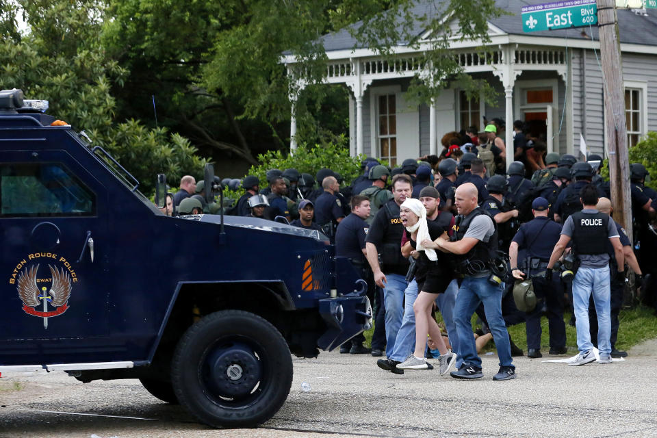 A demonstrator protesting the shooting death of Alton Sterling is detained by law enforcement officers in Baton Rouge, Louisiana, U.S., July 10, 2016.  REUTERS/Jonathan Bachman TPX IMAGES OF THE DAY     