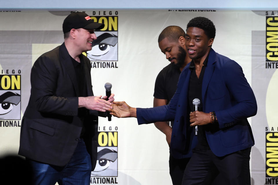 Chadwick and Kevin shake hands on a stage