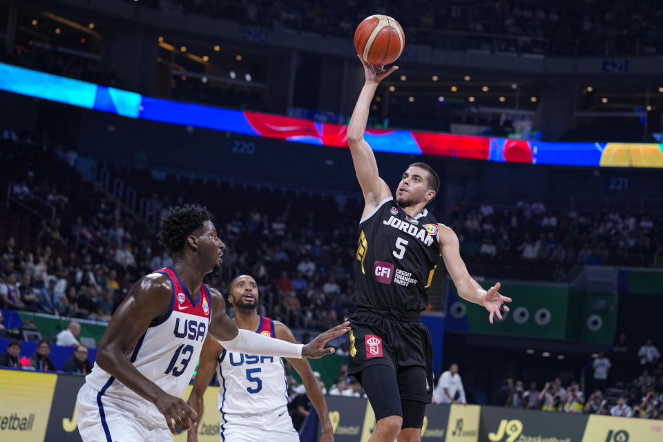 Jordan guard Freddy Ibrahim (5) shoots over U.S. forward Jaren Jackson Jr. (13) during the first half of a Basketball World Cup group C match in Manila, Philippines Wednesday, Aug. 30, 2023. (AP Photo/Michael Conroy)