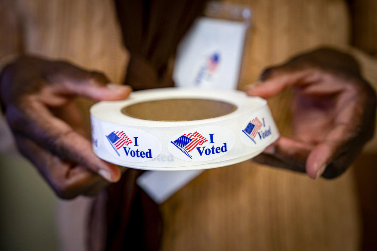 A person hols a roll of "I Voted" stickers. (Allison Joyce / Bloomberg via Getty Images)