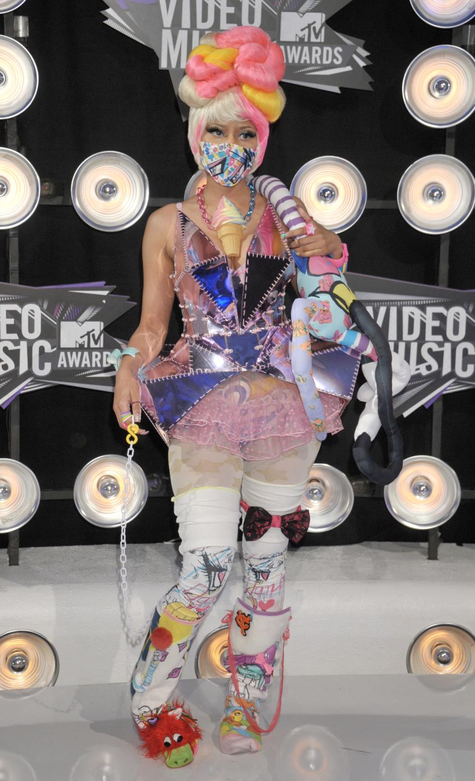 Nicki Minaj in an extravagant costume featuring an ice cream cone necklace.