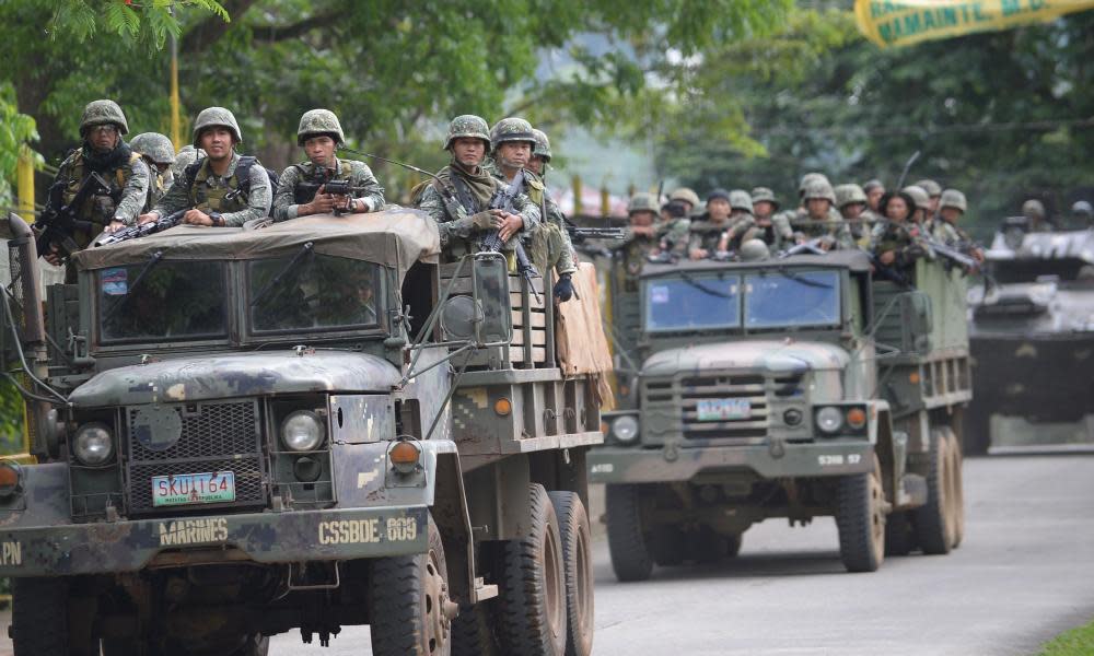 Philippine marines in tanks advancing on a militant base in the city of Marawi