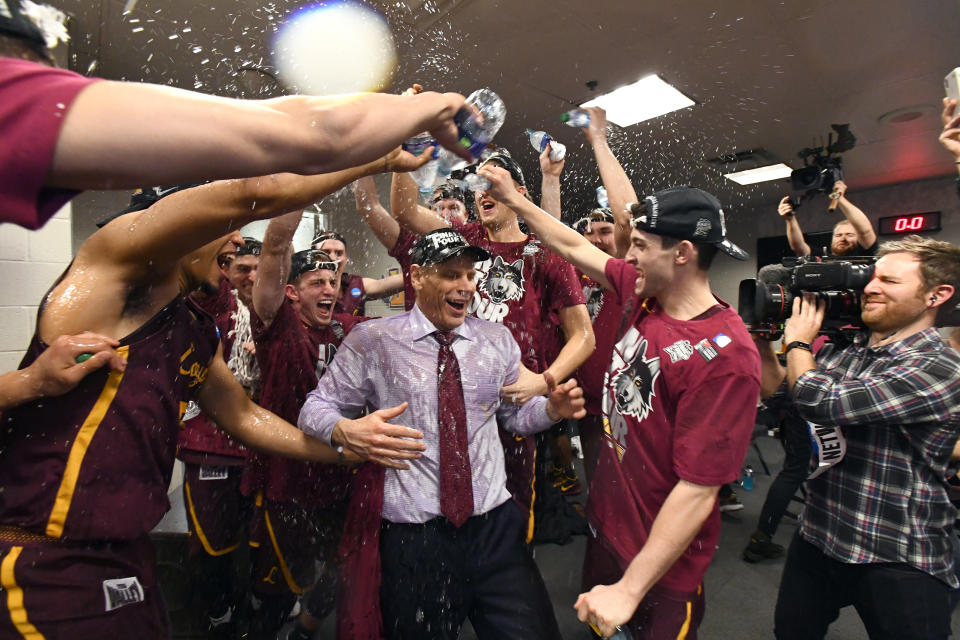 Loyola head coach Porter Moser gets doused by his players after the Ramblers beat Kansas State to advance to the Final Four. (Getty)