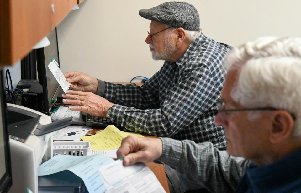 John Gorman and Eddie Piker verify ballot signatures at the Garfield County Courthouse in Glenwood Springs, Colo., on March 3, 2020, for the Super Tuesday primary elections.