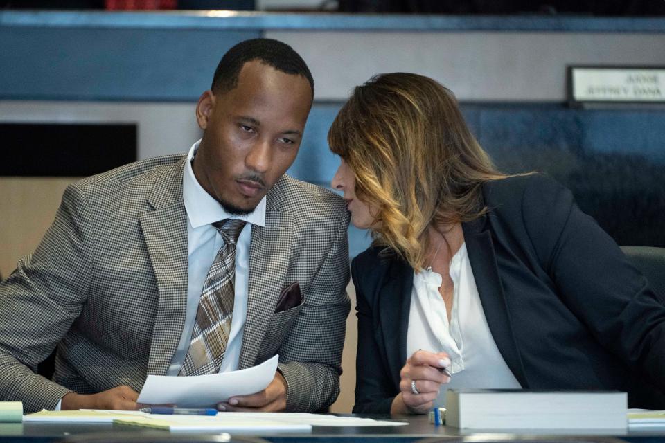 Former Florida State University and NFL wide receiver Travis Rudolph talks to his defense attorney Heidi Perlet before jury selection in his first-degree murder trial in West Palm Beach, Florida on May 19, 2023.