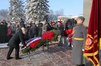 Russian President Vladimir Putin, left, takes part at a wreath laying ceremony at the Piskaryovskoye Cemetery, in St. Petersburg, Russia, Sunday, Jan. 27, 2019, where most of the Leningrad Siege victims were buried during World War II. The Russian city of St. Petersburg marked the 75th anniversary of the end of the World War II siege by Nazi forces. The siege of the city, then called Leningrad, lasted nearly two and a half years until the Soviet Army drove the Nazis away on Jan. 27, 1944. (Mikhail Klimentyev, Sputnik, Kremlin Pool Photo via AP)