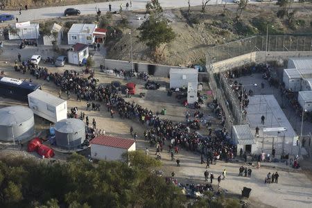 Refugees and migrants wait to be registered at a site on the Greek island of Lesbos, in this handout photo released by the Greek Prime Minister's Office on December 15, 2015. REUTERS/Greek Prime Minister's Office/Handout via Reuters