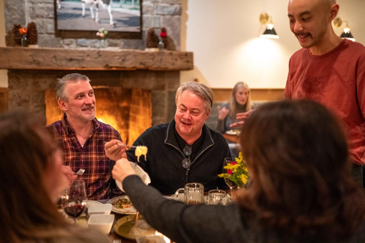 Alpino manager Thomas Chen, right, talks with Eddie Gillis, center, of Flat Rock, and Tom Duffy, left, of Milford as they dine with their wives Wendy Duffy, foreground left, and Angie Gillis at Alpino in Detroit's Corktown neighborhood on Friday, February 16, 2024. The restaurant focuses on a cuisine inspired by the Alps and does so in a warm, elegant environment paired with excellent hospitality.