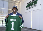 New York Jets offensive tackle Olu Fashanu holds his jersey at the team's training facility in Florham Park, N.J., Friday, April 26, 2024. Fashanu, a Penn State offensive tackle, was selected at No. 11 overall by New York after the Jets traded down one spot Thursday night. (AP Photo/Craig Ruttle)
