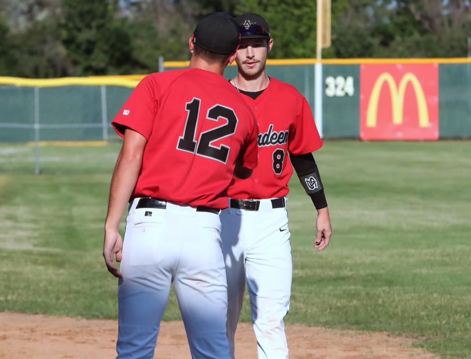 Brian Holmstrom is greeted by Aberdeen Legionn coach Brandon Kusler after being named the Bryce Anglin Memorial Scholarship winner Wednesday night at Fossum Field.