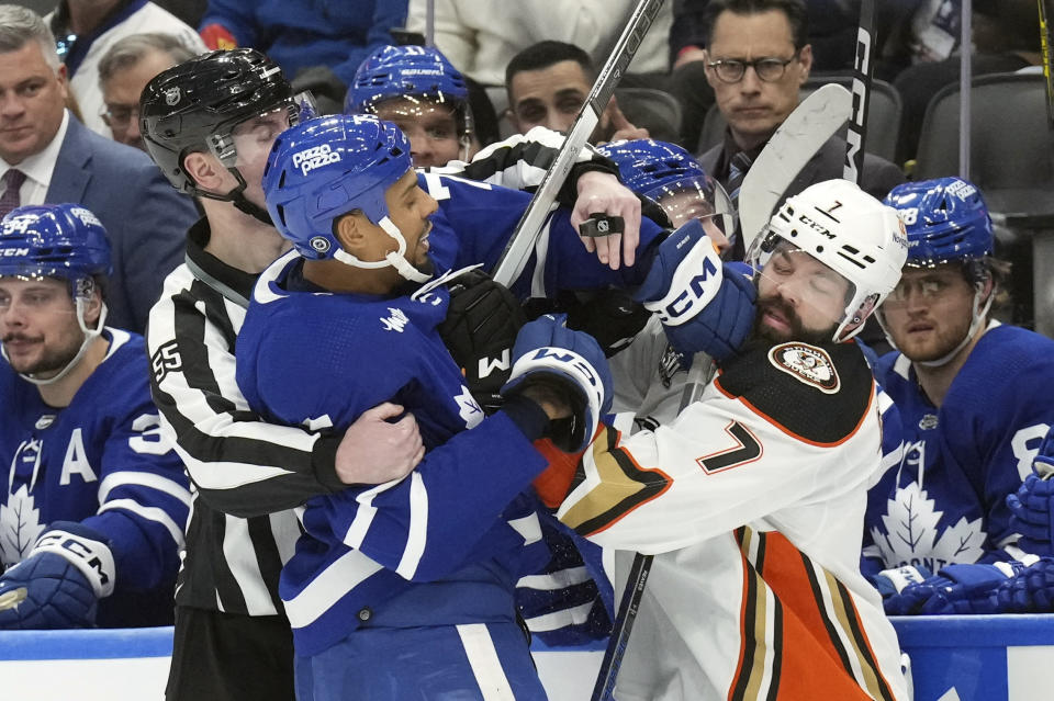 Toronto Maple Leafs' Ryan Reaves, left, and Anaheim Ducks' Radko Gudas push each other during the second period of an NHL hockey game, Saturday, Feb. 17, 2024 in Toronto. (Chris Young/The Canadian Press via AP)