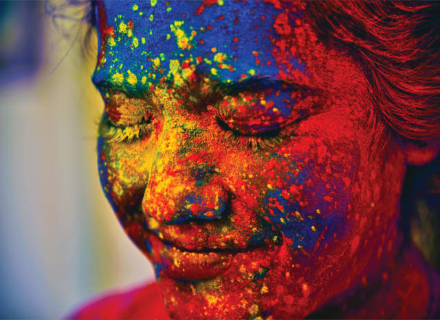 What is Holi, and why do people throw colored powder to celebrate?