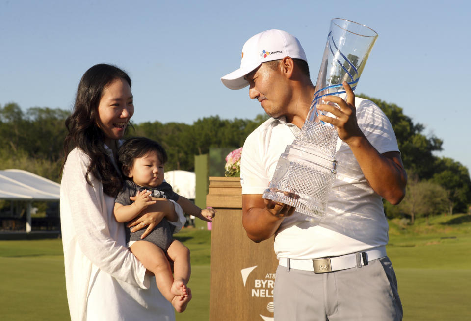 Sung Sang, winner of the Byron Nelson golf tournament, shows his wife Soyoung Yang and son Eugene Gunn Kang the trophy Sunday, May 12, 2019, in Dallas. (AP Photo/Richard W. Rodriguez)