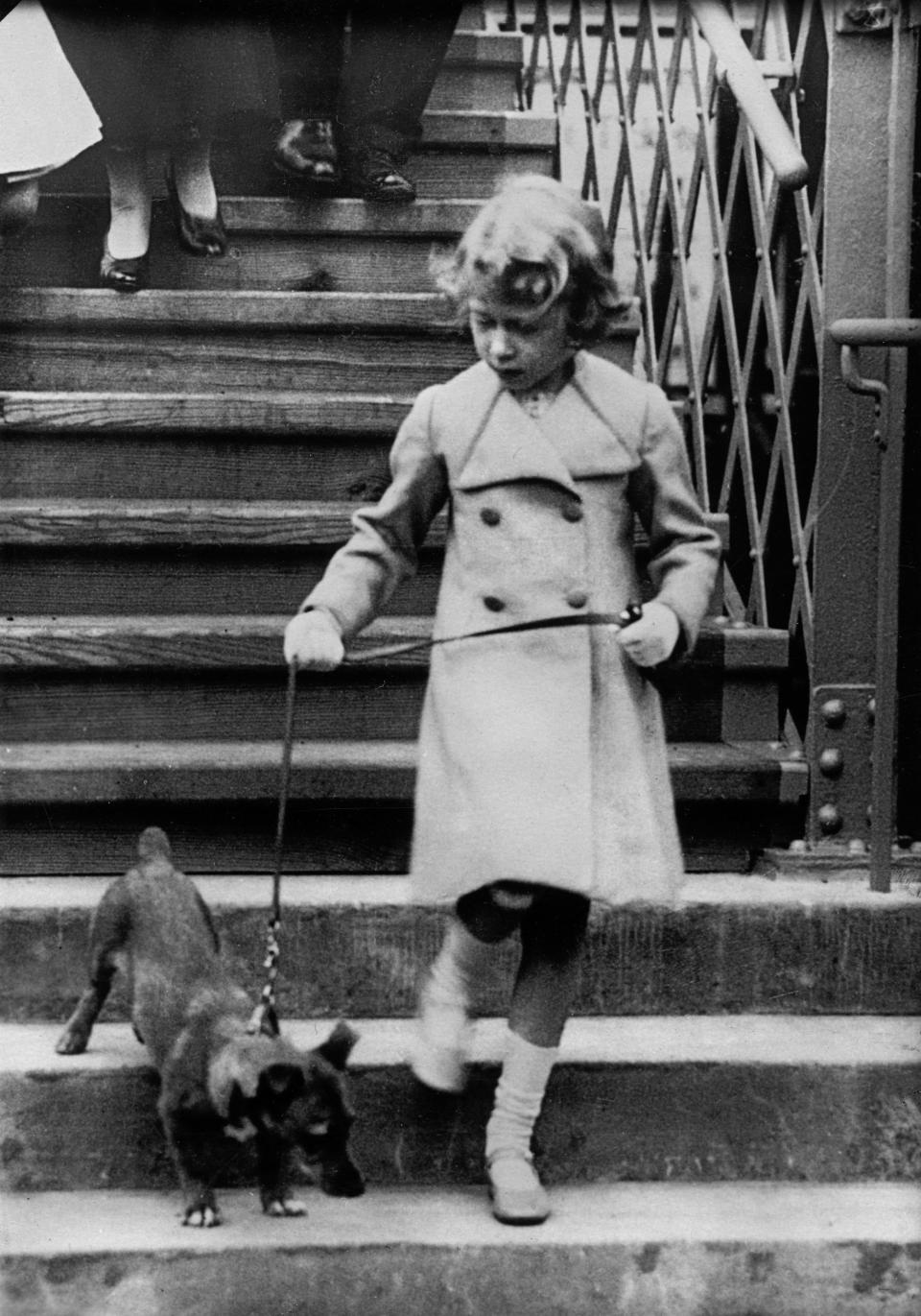 UNITED KINGDOM - CIRCA 1931: Princess Elizabeth of England takes her dog for a walk. Photograph. Around 1931. (Photo by Imagno/Getty Images)