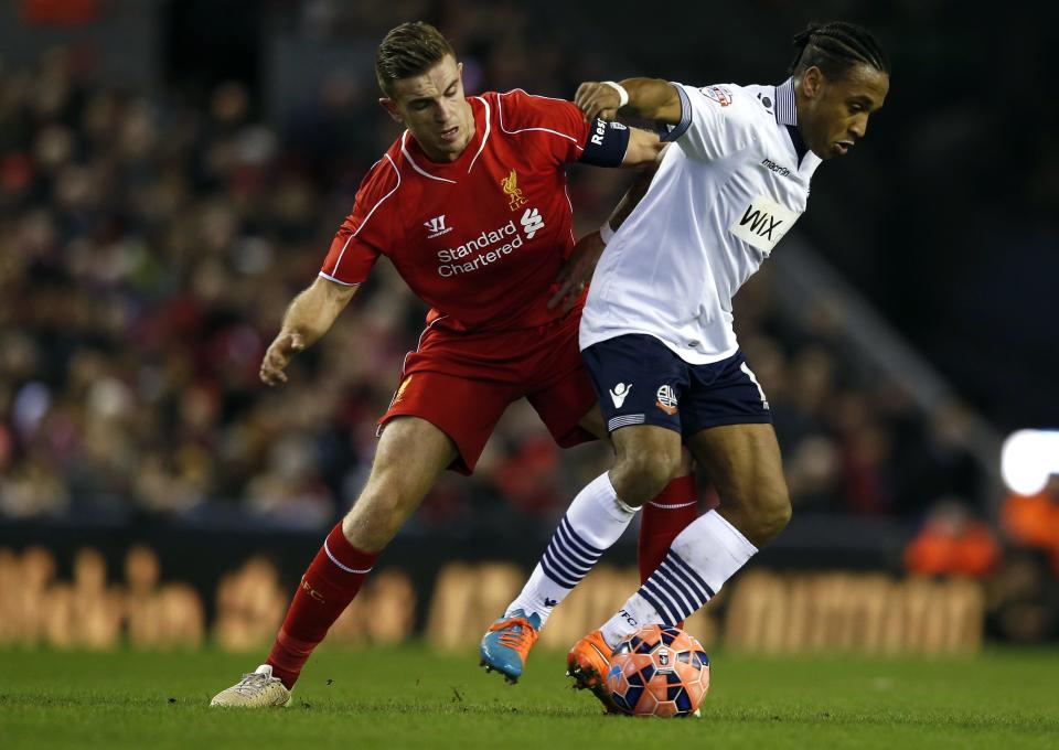 Liverpool's Jordan Henderson (L) challenges Bolton Wanderers' Neil Danns during their FA Cup fourth round soccer match at Anfield in Liverpool, northern England January 24, 2015. REUTERS/Phil Noble (BRITAIN - Tags: SPORT SOCCER)