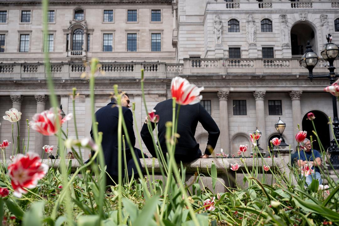 Lunchtime City workers rest in front of the  Bank of England at the City of London's Bank junction, in the heart of the capital's financial district, on 15th May 2024, in London, England.