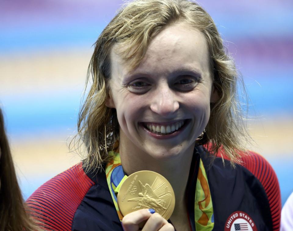 Katie Ledecky poses with her fourth gold medal of the Rio Games. (Reuters)