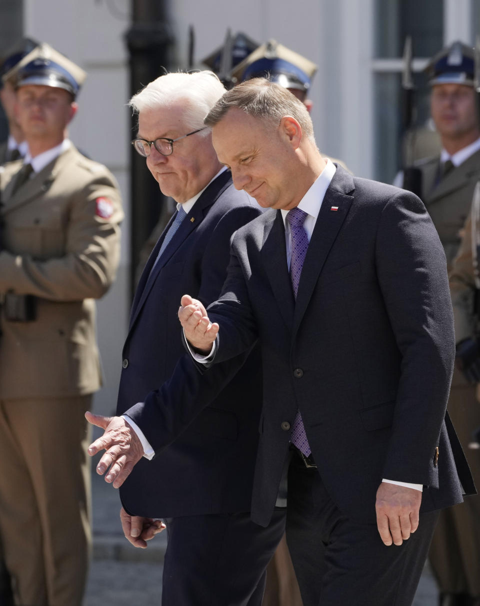 Germany's President Frank-Walter Steinmeier, front left, and his Polish host, President Andrzej Duda, front right, gesture as they attend a military welcome ceremony at the Presidential Palace in Warsaw, Poland, Thursday, June 17, 2021 at the start of Steinmeier's brief visit marking 30 years of bilateral good-neighborly relations treaty. Their talks are expected to include the future of the European Union and its tran-Atlantic ties, the developments in Ukraine and Belarus and the divisive Nord Stream 2 gas pipeline between Russia and Germany. (AP Photo/Czarek Sokolowski)