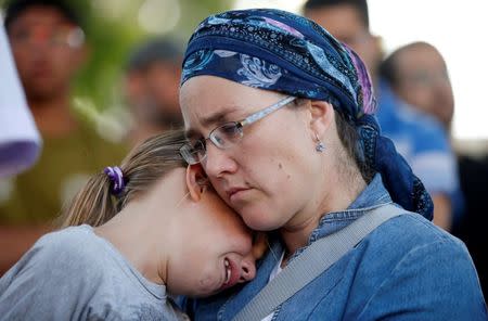 People mourn during the funeral of Israeli girl, Hallel Yaffa Ariel, 13, who was killed in a Palestinian stabbing attack in her home in the West Bank Jewish settlement of Kiryat Arba, at a cemetery in the West Bank city of Hebron June 30, 2016. REUTERS/Ronen Zvulun