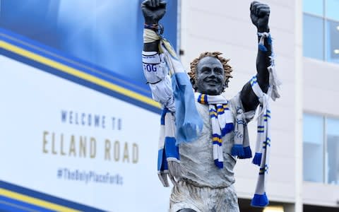 Scarves are draped over a statue of Leeds legend Billy Bremner - Credit: getty images