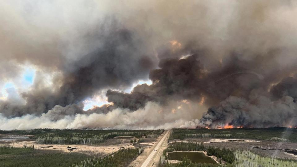 Smoke rises from the Mutual Aid Wildfire HTZ001 in the High-Level Forest Area, which originated in the Northwest Territories in 2023 but flared due to strong winds near Indian Cabins, Alberta, Canada, on May 10, 2024.  (Handout via Reuters) (Alberta Wildfire/via Reuters)