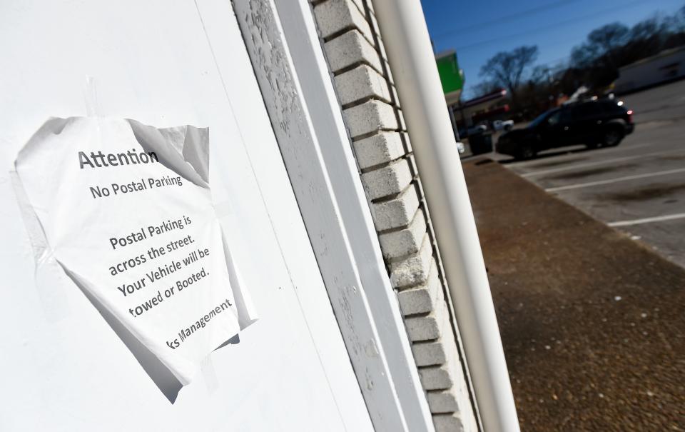 A sign informing residents that their cars maybe booted if parked in a lot next to the United State Postal Office, Jere Baxter Branch, on Monday, Feb. 5, 2024, in Nashville, Tenn.